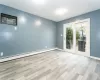 Empty room featuring baseboard heating and light hardwood / wood-style floors