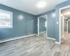 Unfurnished room featuring light hardwood / wood-style floors and a baseboard radiator