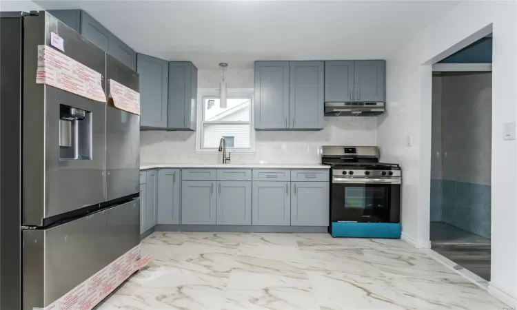 Kitchen with sink and appliances with stainless steel finishes