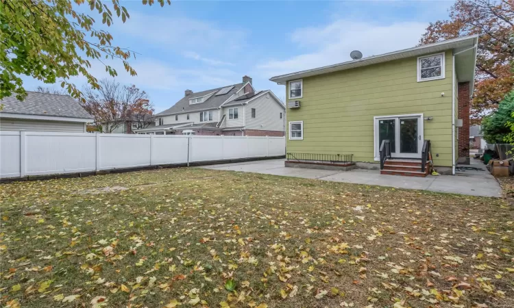 Back of property featuring a patio area and a lawn