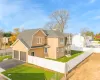 View of front of home featuring a front yard and a garage