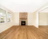 Unfurnished living room with a fireplace and light hardwood / wood-style floors