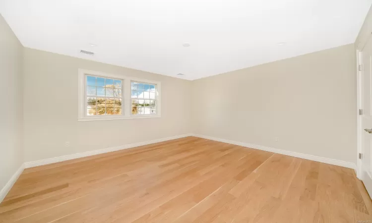 Unfurnished room with light wood-type flooring