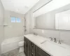 Full bathroom featuring decorative backsplash, vanity, tile walls, toilet, and tiled shower / bath