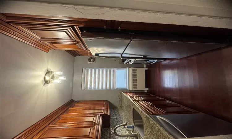 Kitchen featuring dishwasher, sink, dark hardwood / wood-style flooring, radiator heating unit, and stainless steel refrigerator