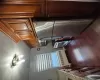 Kitchen featuring radiator, stainless steel range, light stone counters, dark hardwood / wood-style flooring, and fridge