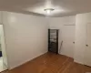 Empty room featuring dark hardwood / wood-style flooring and radiator