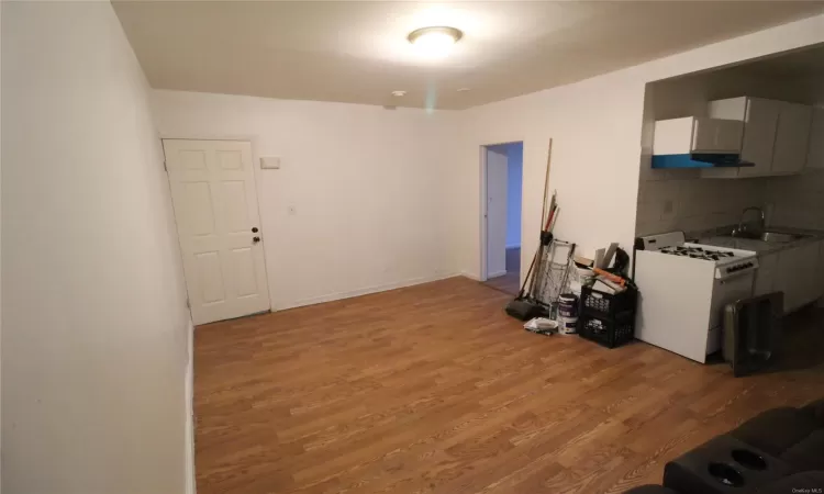 Unfurnished bedroom with dark wood-type flooring and radiator