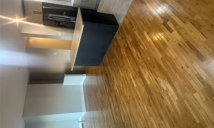 Kitchen with fridge, a center island, and light wood-type flooring