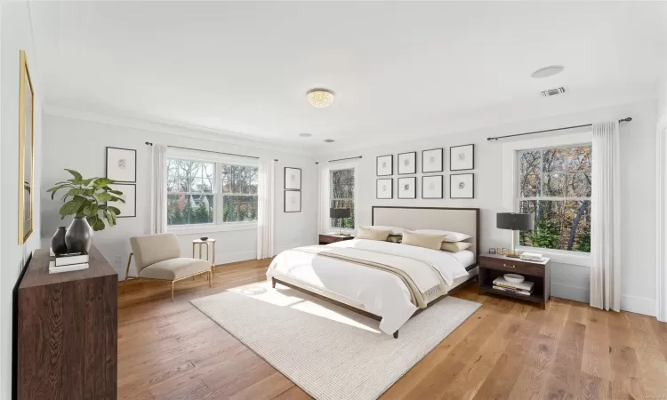 Bedroom with crown molding and light hardwood / wood-style flooring