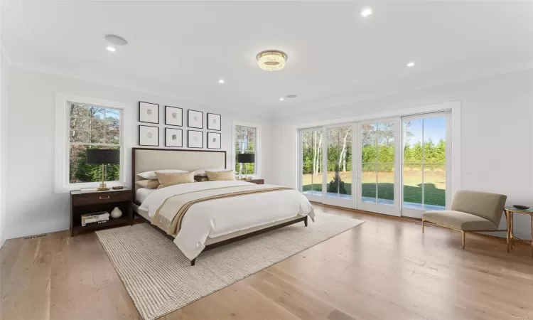 Bedroom featuring access to outside, multiple windows, and light wood-type flooring