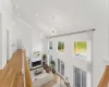 Living room featuring light wood-type flooring, high vaulted ceiling, and a notable chandelier