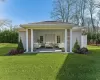 Back of property featuring a lawn and an outdoor living space