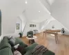 Living room featuring light wood-type flooring and vaulted ceiling