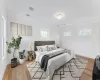 Bedroom featuring ornamental molding and light hardwood / wood-style flooring