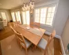 Stairs with baseboards, ornamental molding, wood finished floors, a notable chandelier, and recessed lighting