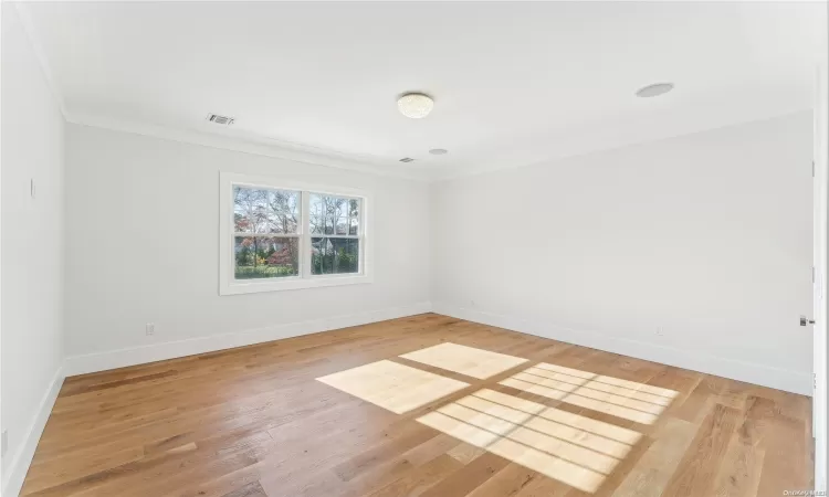 Living room featuring an inviting chandelier, high vaulted ceiling, and light wood-type flooring