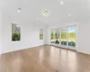 Unfurnished dining area featuring beam ceiling, light hardwood / wood-style flooring, coffered ceiling, and ornamental molding