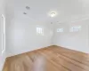 Bedroom featuring access to outside, light hardwood / wood-style flooring, and multiple windows