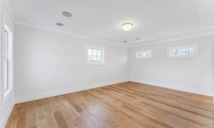 Bedroom featuring access to outside, light hardwood / wood-style flooring, and multiple windows