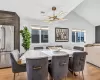 Dining space with an inviting chandelier, light wood-type flooring, and vaulted ceiling