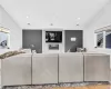 Living room with hardwood / wood-style floors, lofted ceiling, and a wealth of natural light