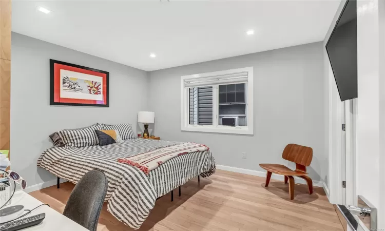 Bedroom with light hardwood / wood-style flooring