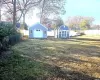 Rear view of house with a yard and a wooden deck