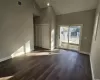 Kitchen featuring white cabinets, sink, dark hardwood / wood-style floors, light stone countertops, and appliances with stainless steel finishes