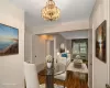 Dining space featuring hardwood / wood-style flooring, a notable chandelier, and a baseboard heating unit