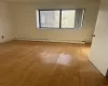 Empty room featuring light hardwood / wood-style flooring and a baseboard heating unit