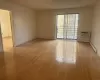 Spare room with a wall mounted air conditioner, light hardwood / wood-style floors, and baseboard heating