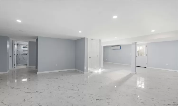 Basement with a wall mounted air conditioner