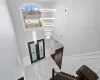 Entrance foyer with a chandelier, wood-type flooring, a high ceiling, and french doors