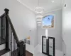 Foyer with french doors, an inviting chandelier, and crown molding