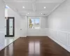 Foyer entrance with beam ceiling, french doors, coffered ceiling, dark hardwood / wood-style flooring, and crown molding