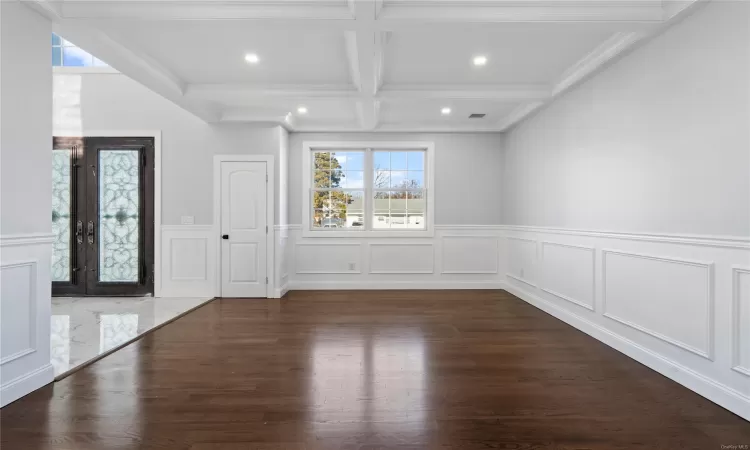 Foyer entrance with beam ceiling, french doors, coffered ceiling, dark hardwood / wood-style flooring, and crown molding