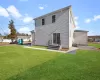 Back of house featuring central AC unit and a lawn