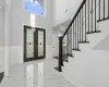 Foyer featuring french doors and a high ceiling