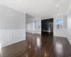 Unfurnished living room with dark hardwood / wood-style floors, ornamental molding, a wealth of natural light, and a premium fireplace