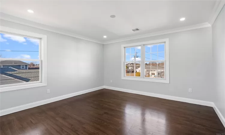 Spare room with dark hardwood / wood-style flooring and ornamental molding