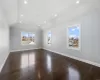 Spare room with dark hardwood / wood-style floors and lofted ceiling