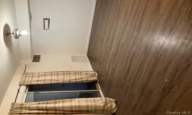 Spare room featuring dark wood-type flooring