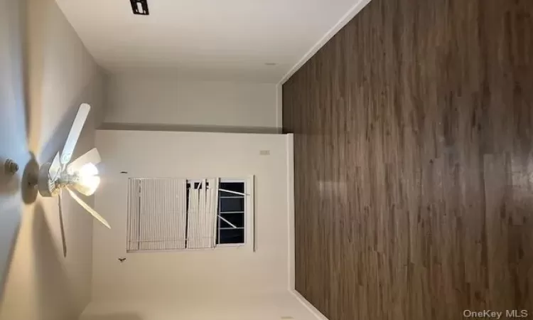 Spare room featuring dark hardwood / wood-style floors and ceiling fan