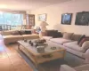 Living room with crown molding, parquet floors, and an inviting chandelier