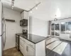 Kitchen featuring dark hardwood / wood-style floors, white cabinetry, stainless steel appliances, and tile walls