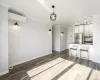 Unfurnished living room featuring crown molding, an AC wall unit, and dark wood-type flooring