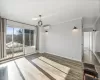 Unfurnished room with a wall mounted AC, an inviting chandelier, dark wood-type flooring, and ornamental molding