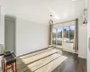 Empty room featuring dark hardwood / wood-style flooring, an AC wall unit, and ornamental molding