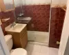 Bathroom featuring vanity, tile patterned flooring, toilet, tile walls, and an enclosed shower